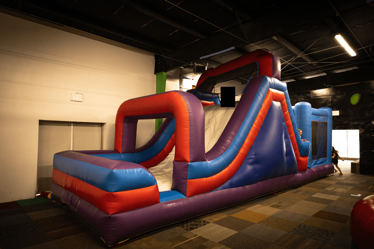 A bouncy playground-style inflatable with obstacles.