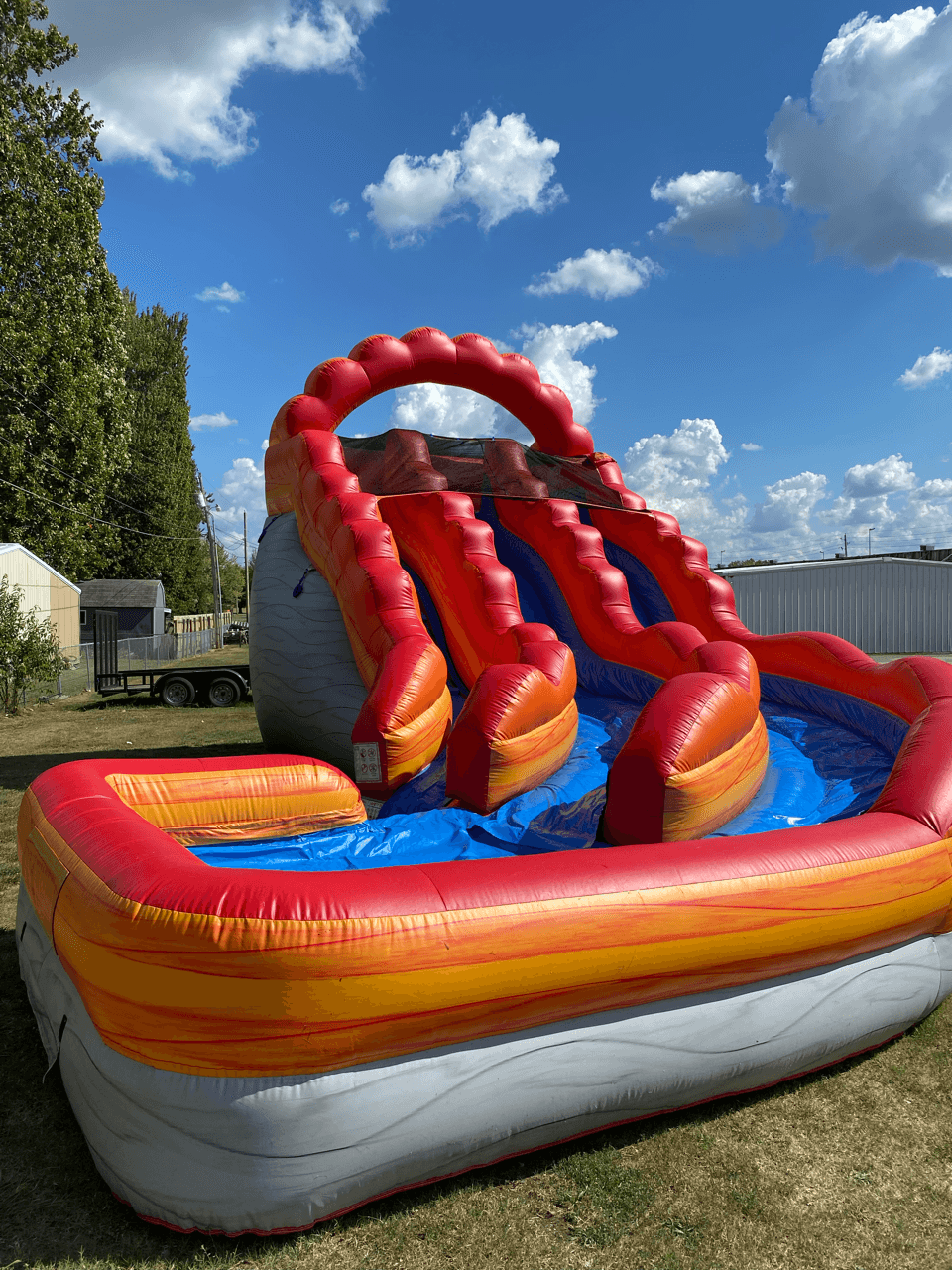 A large inflatable slide with a pool area.