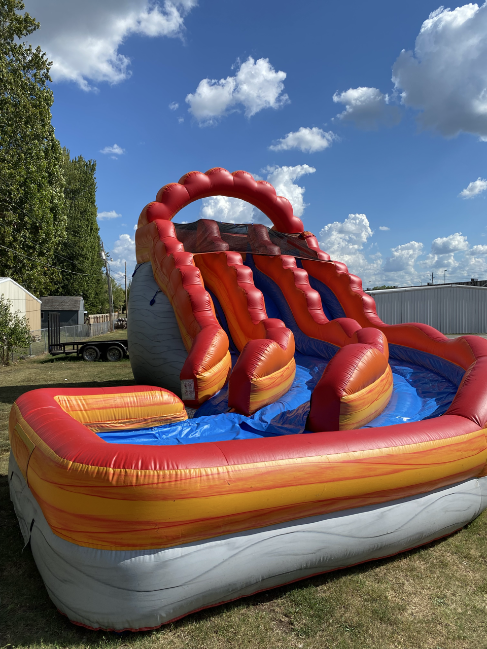 A large inflatable slide with a pool area.